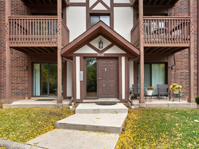 a front view of a house with outdoor seating