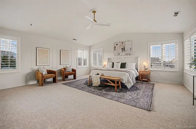 a spacious bedroom with a bed and a window