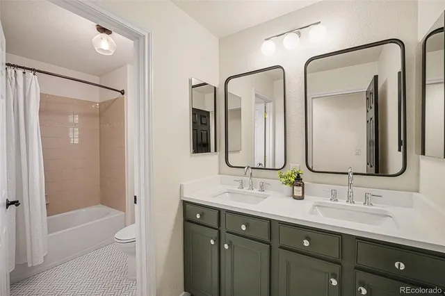 a bathroom with a double vanity sink mirror double and a bathtub
