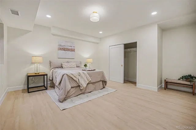 a bedroom with a bed and a night stand