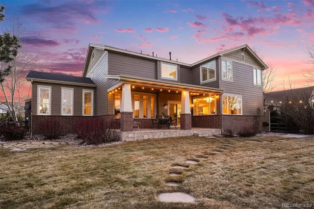 a view of house with yard and sitting area