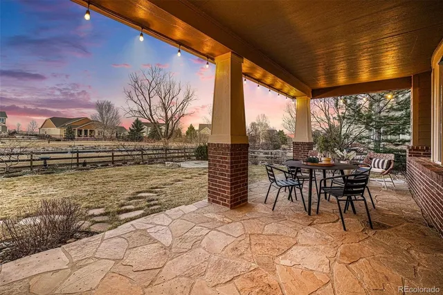 a view of a patio with table and chairs floor to ceiling window with yard and mountain view