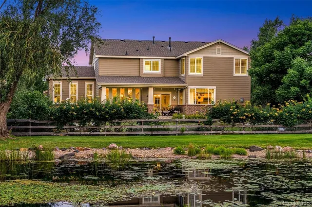 a front view of a house with a yard with swimming pool