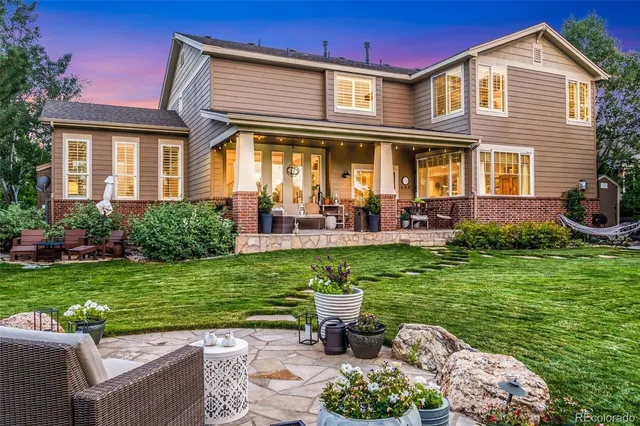 a view of a house with backyard sitting area and garden