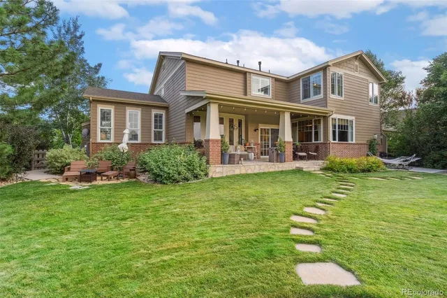 a front view of house with yard and green space