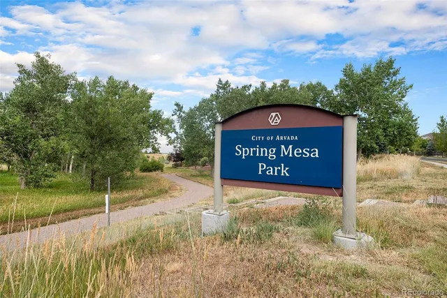 a view of a street sign under a large tree