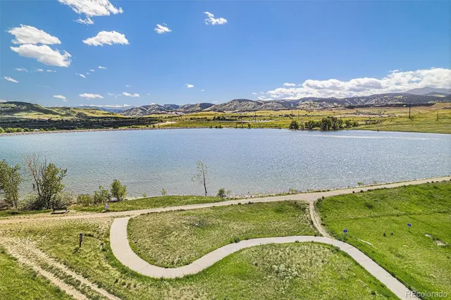 a view of a swimming pool with a lake view and mountain view
