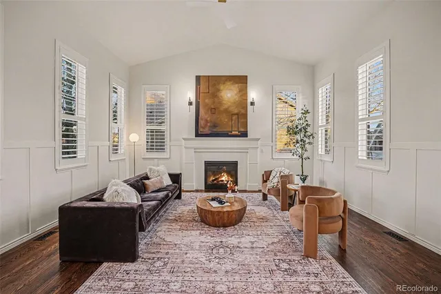 a living room with furniture a rug and a fireplace