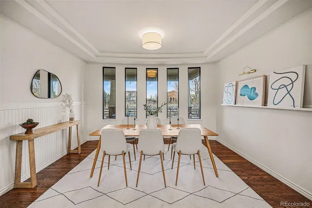 a view of a dining room with furniture wooden floor and a rug