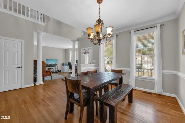 a view of a dining room with furniture window and wooden floor