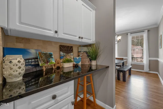 a kitchen with stainless steel appliances granite countertop a stove and white cabinets