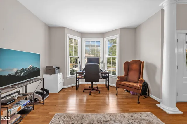 a living room with furniture and a lamp