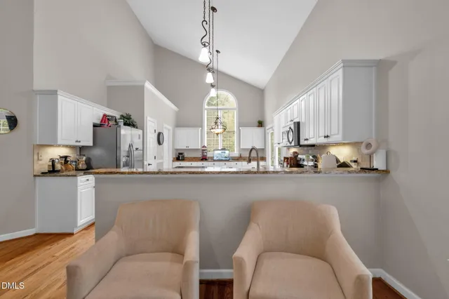 a kitchen with stainless steel appliances granite countertop a white cabinets stove a sink and dishwasher