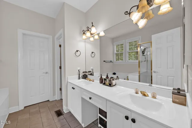 a bathroom with a bathtub a window and a shower