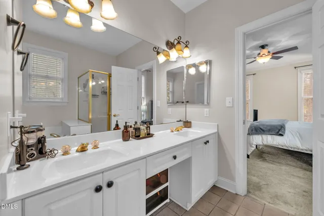 a view of staircase with lots of frames on wall and a window