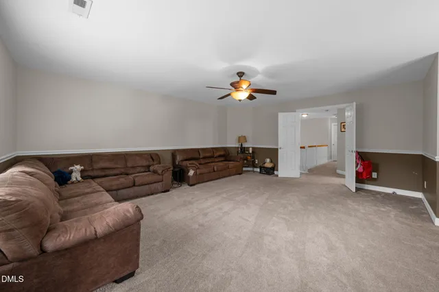 a living room with furniture a couch and a flat screen tv