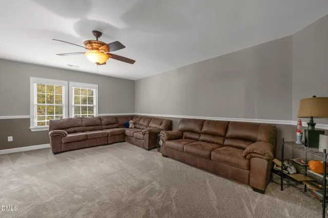 a bedroom with bed and a large window