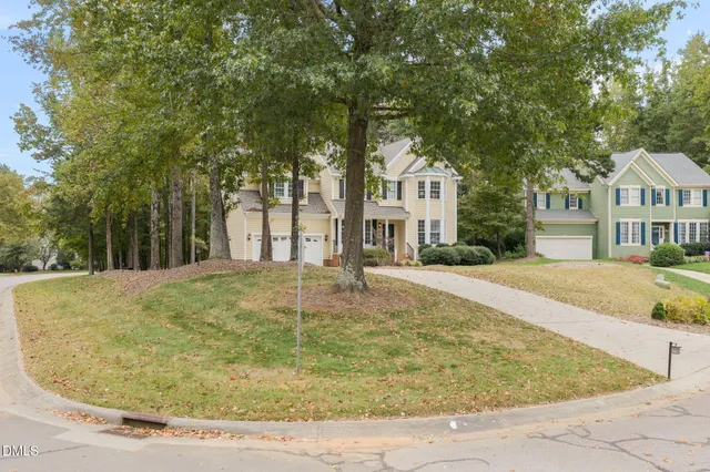an aerial view of a house with a yard and a fountain