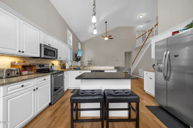 a kitchen with furniture a counter space a sink appliances and cabinets
