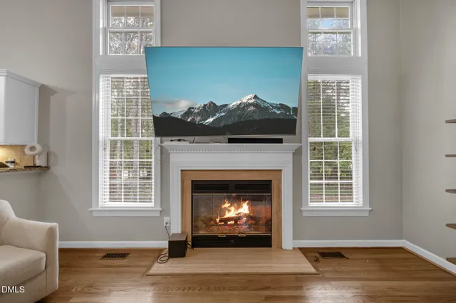 a living room with a fireplace and windows