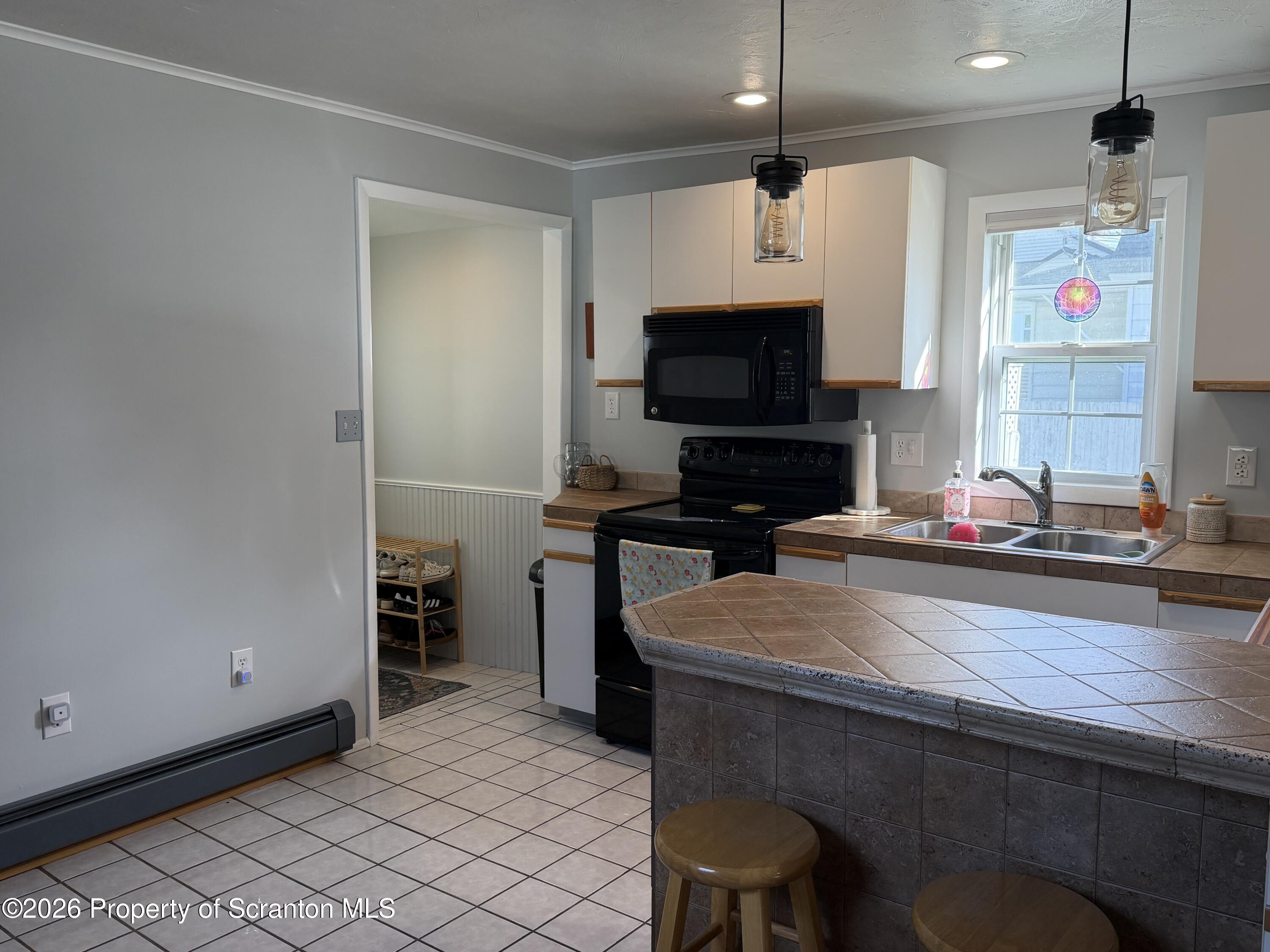 320 Haverly Street Throop, PA 18512 - Photo 9 of 27 a kitchen with a sink appliances and cabinets