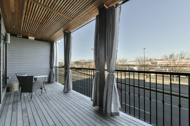 a view of a balcony with wooden floor
