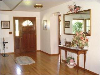 425 Sierra Vista Road Santa Rosa, CA 95401 - Photo 8 of 11 a view of a hallway with wooden floor windows and chandelier