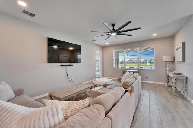 a spacious bedroom with a bed and a chandelier