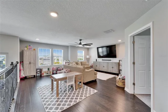 a bedroom with a bed and a ceiling fan