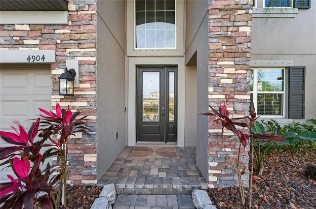 a kitchen with stainless steel appliances granite countertop a table chairs sink refrigerator and cabinets