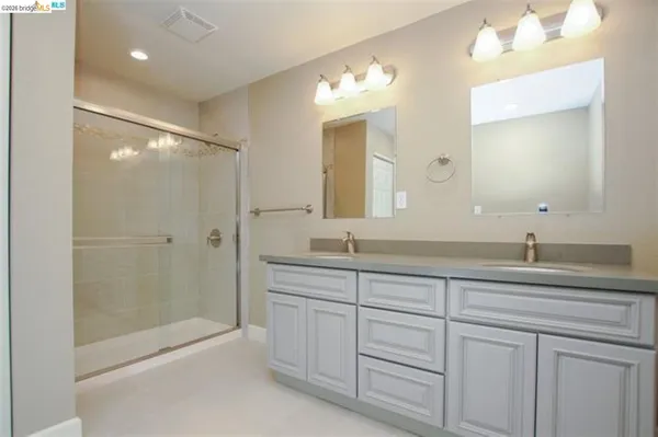 a bathroom with a granite countertop sink mirror and