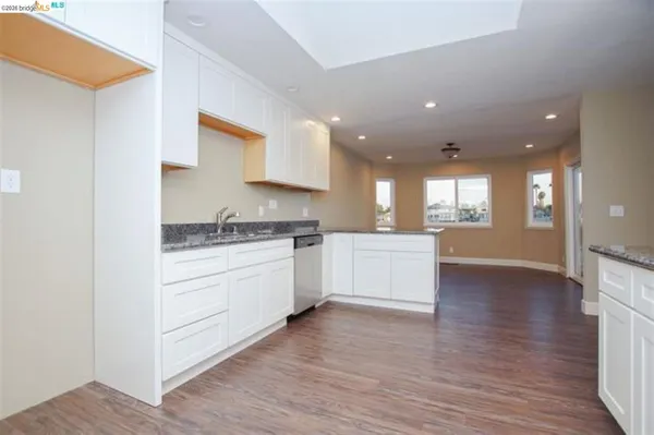 a kitchen with a white cabinets stove and kitchen island