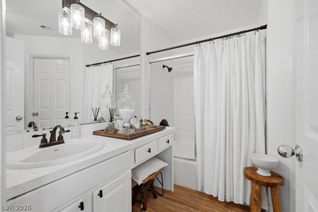 6250 West Flamingo Road, Unit 93 Las Vegas, NV 89103 - Photo 26 of 38 This bright bathroom features a spacious vanity with ample counter space and a classic shower-tub combination.
