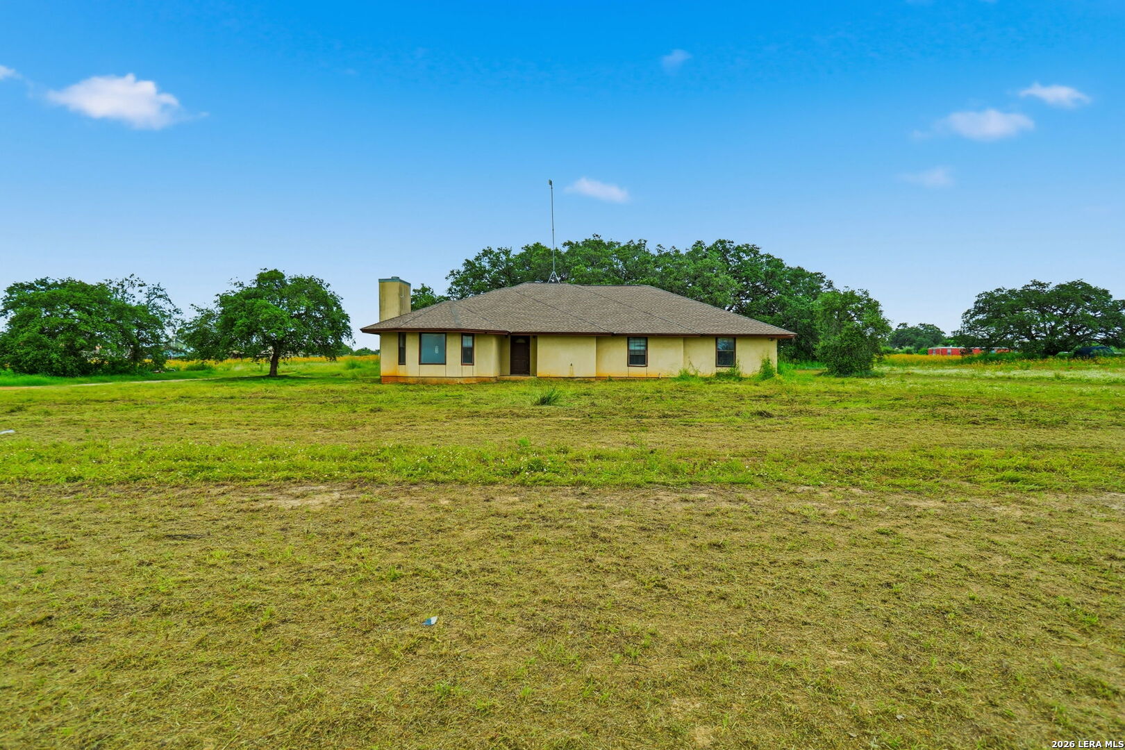 3061 Horse Ranch Road San Antonio, TX 78264 - Photo 29 of 34 a backyard of a house with lots of green space