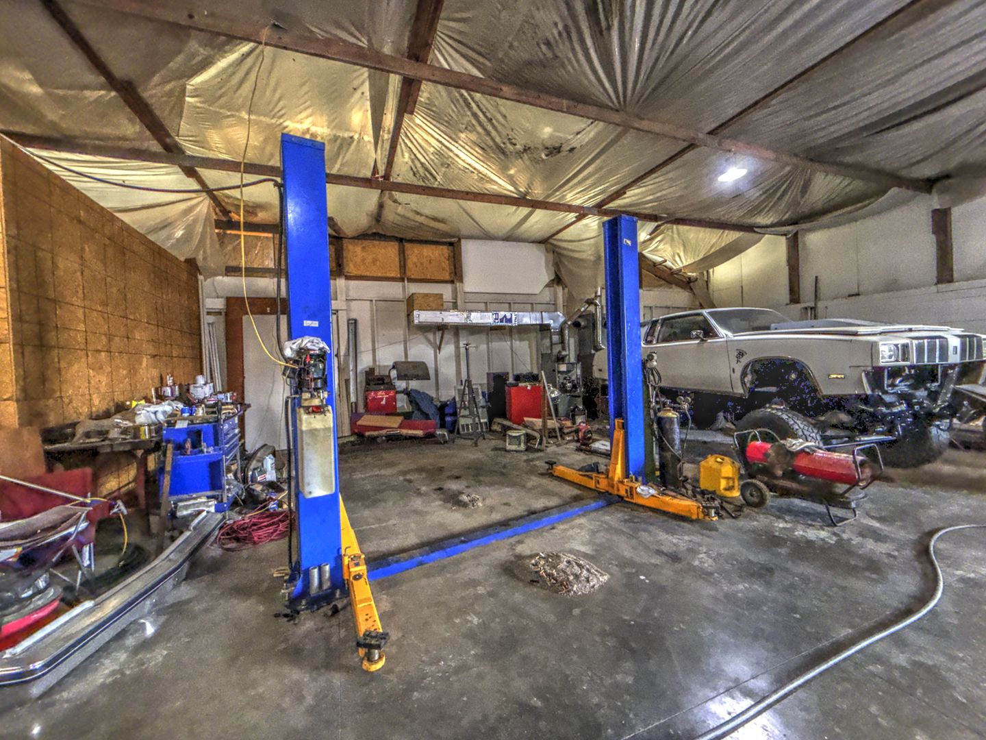 210 Hamilton Street Wellington, IL 60973 - Photo 19 of 21 a view of a garage with a bike and a table and chairs