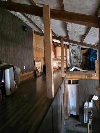 a view of a living room with a sink and wooden floor