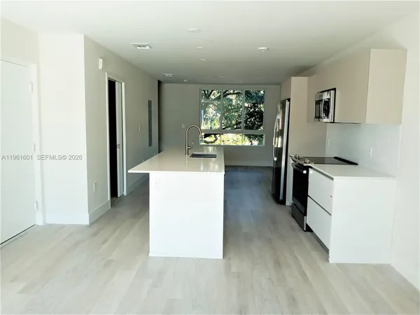 a view of kitchen with cabinets and wooden floor