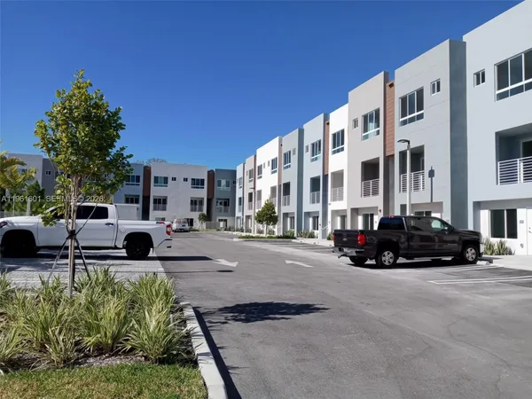 a view of cars parked in front of a building