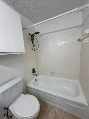 a bathroom with a toilet and a bathtub