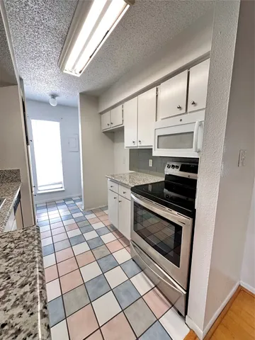 a kitchen with a stove a sink and a refrigerator