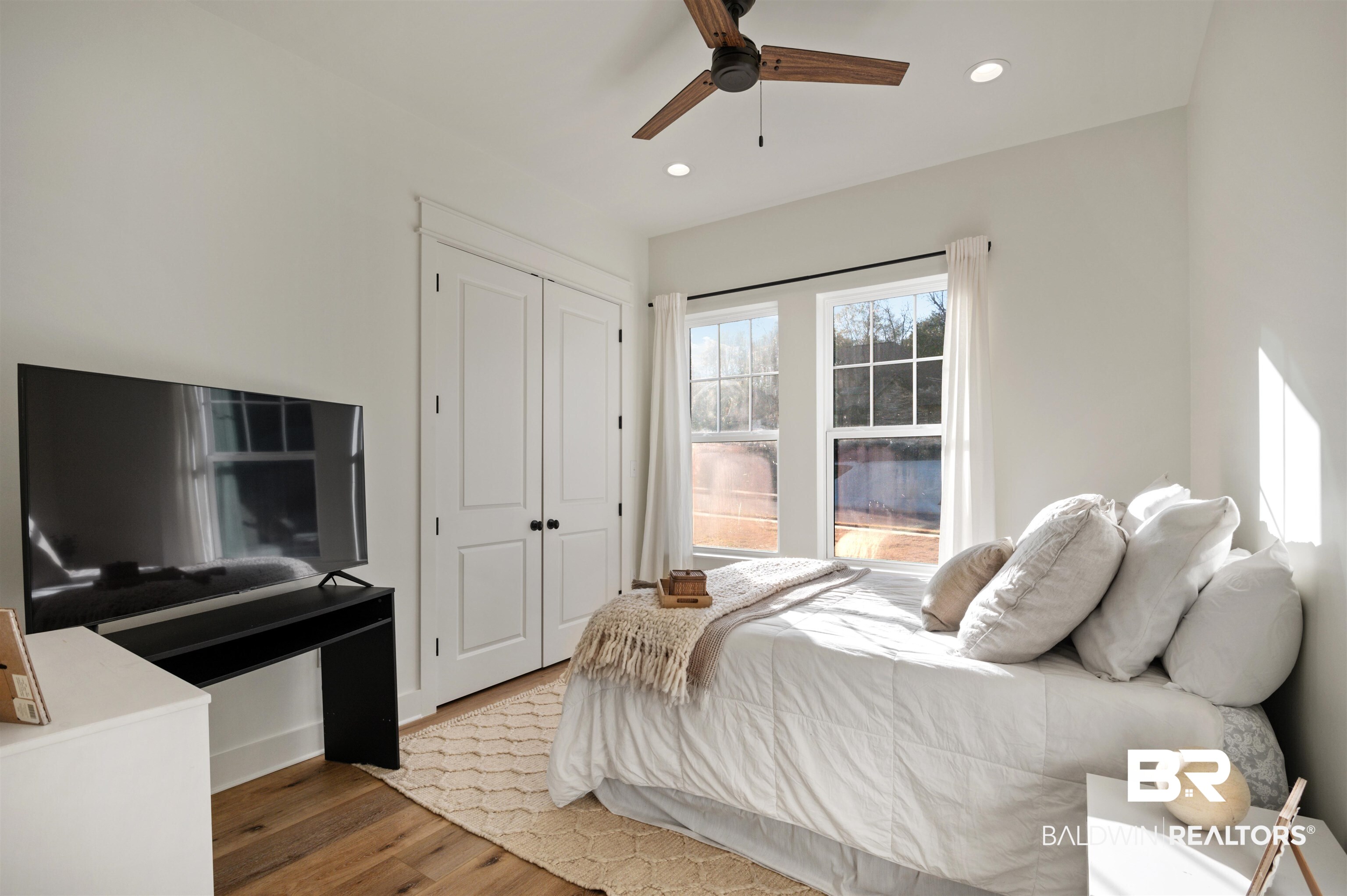 312 Pecan Ridge Boulevard Fairhope, AL 36532 - Photo 30 of 43 Bedroom featuring ceiling fan, a closet, and hardwood / wood-style flooring