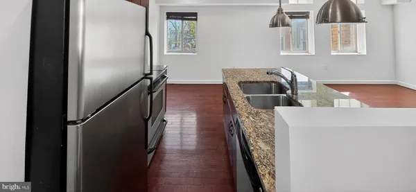 a hallway with front door wooden floor and windows