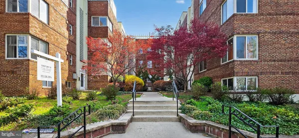 a front view of a multi story building with a yard