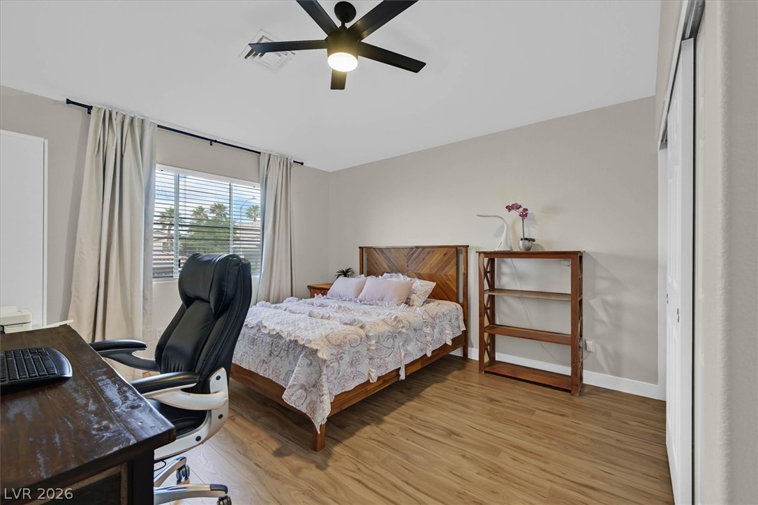 1259 Moon Vision Street Henderson, NV 89052 - Photo 30 of 53 A well-lit bedroom provides ample space for rest or a dedicated home office setup.