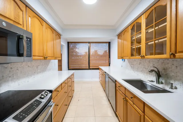 a kitchen with sink and large window