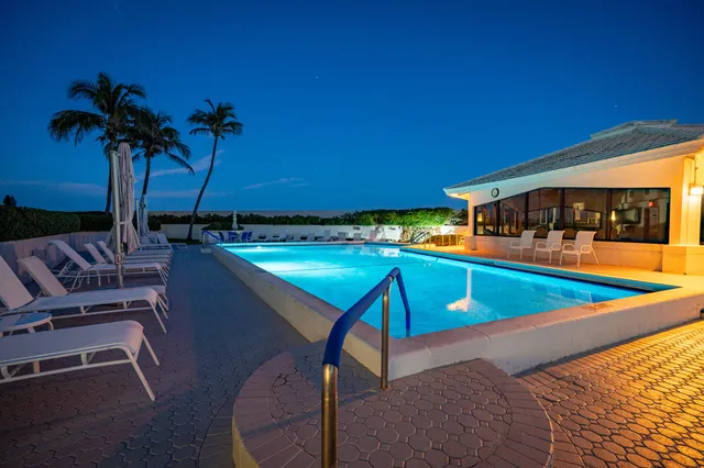 a view of a swimming pool with outdoor seating