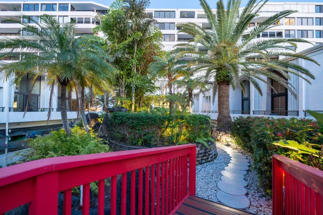 a view of a house with a yard and potted plants