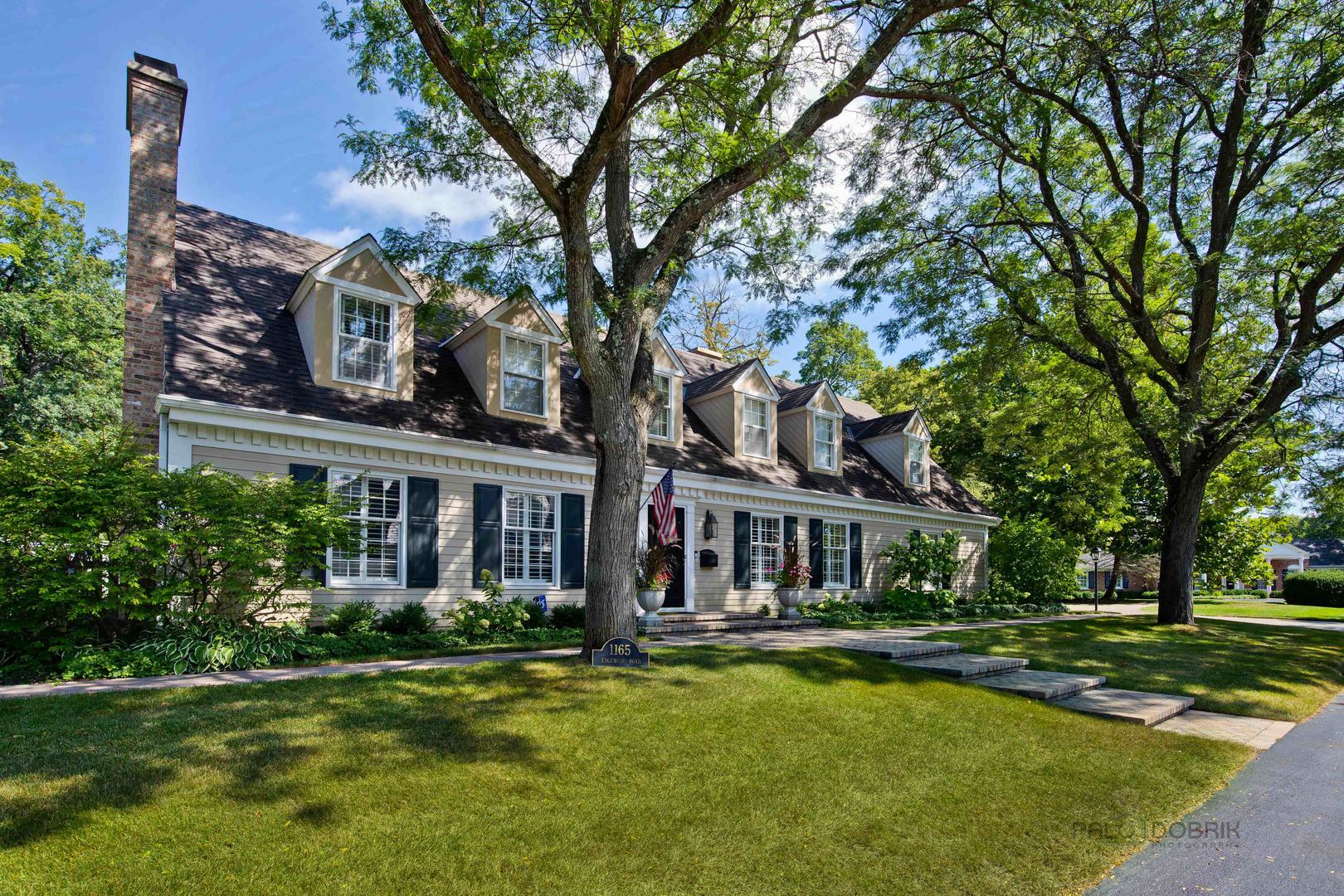 Undisclosed Address Lake Forest, IL 60045 - Photo 3 of 50 a front view of a house with swimming pool and garden