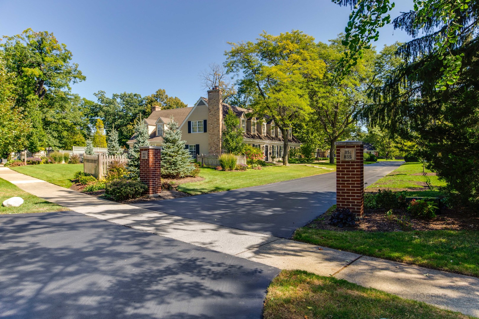 Undisclosed Address Lake Forest, IL 60045 - Photo 4 of 50 a front view of a house with a yard and tree s