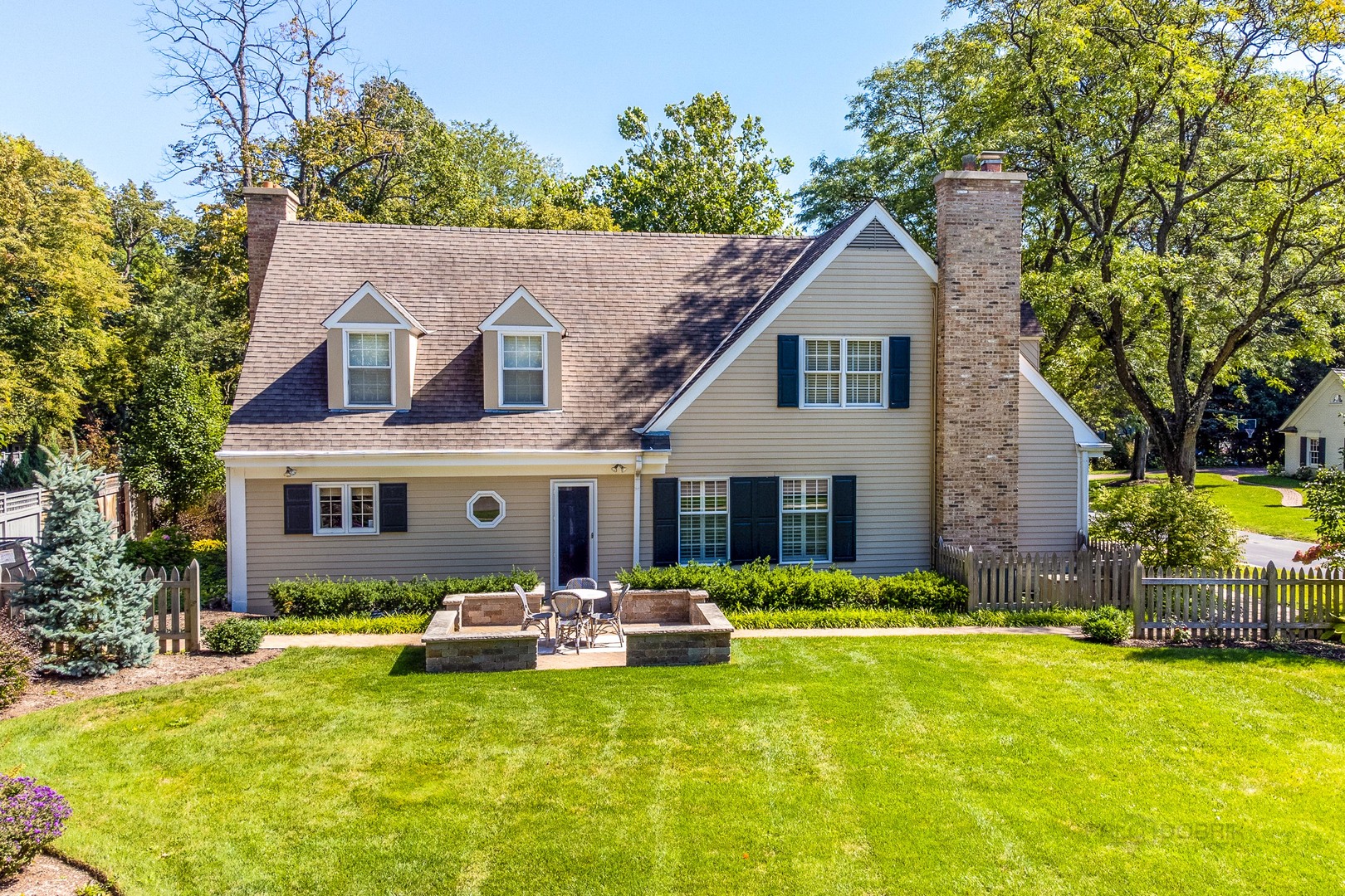Undisclosed Address Lake Forest, IL 60045 - Photo 46 of 50 a backyard of a house with table and chairs under an umbrella
